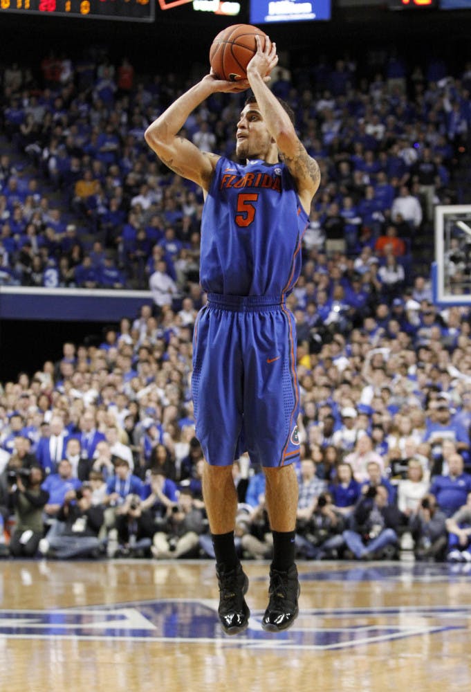 Scottie Wilbekin shoots an uncontested three-point shot during Florida’s 69-59 win against Kentucky on Saturday in Lexington, Ky. Wilbekin scored a career-high 23 points in the win, which was the Gators’ first in Rupp Arena since 2007.