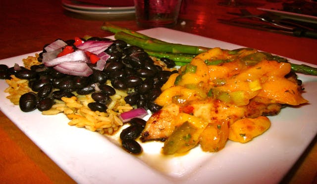 Chicken with spicy mango jalapeño salsa, black beans over Spanish rice and asparagus.