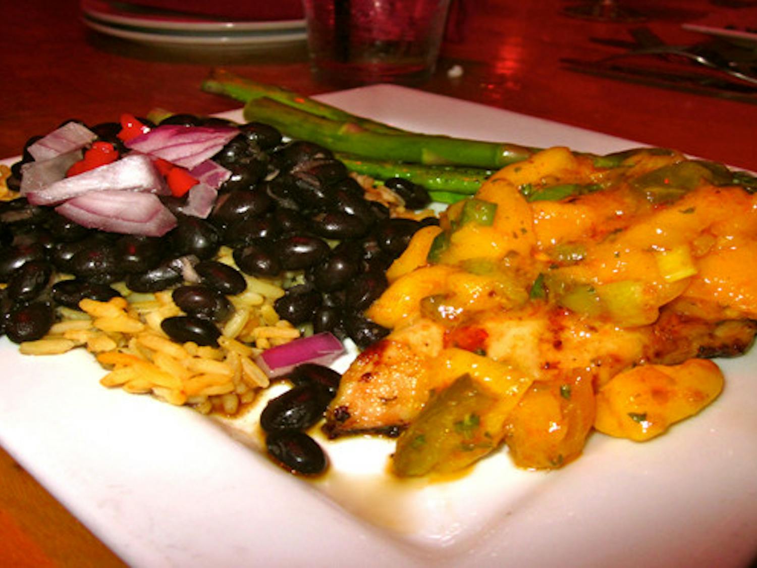 Chicken with spicy mango jalapeño salsa, black beans over Spanish rice and asparagus.