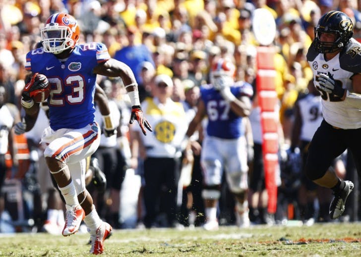 Running back Mike Gillislee (23) runs toward the end zone while being chased by Missouri linebacker Will Ebner (32) during Florida’s 14-7 win on Saturday at Ben Hill Griffin Stadium.
