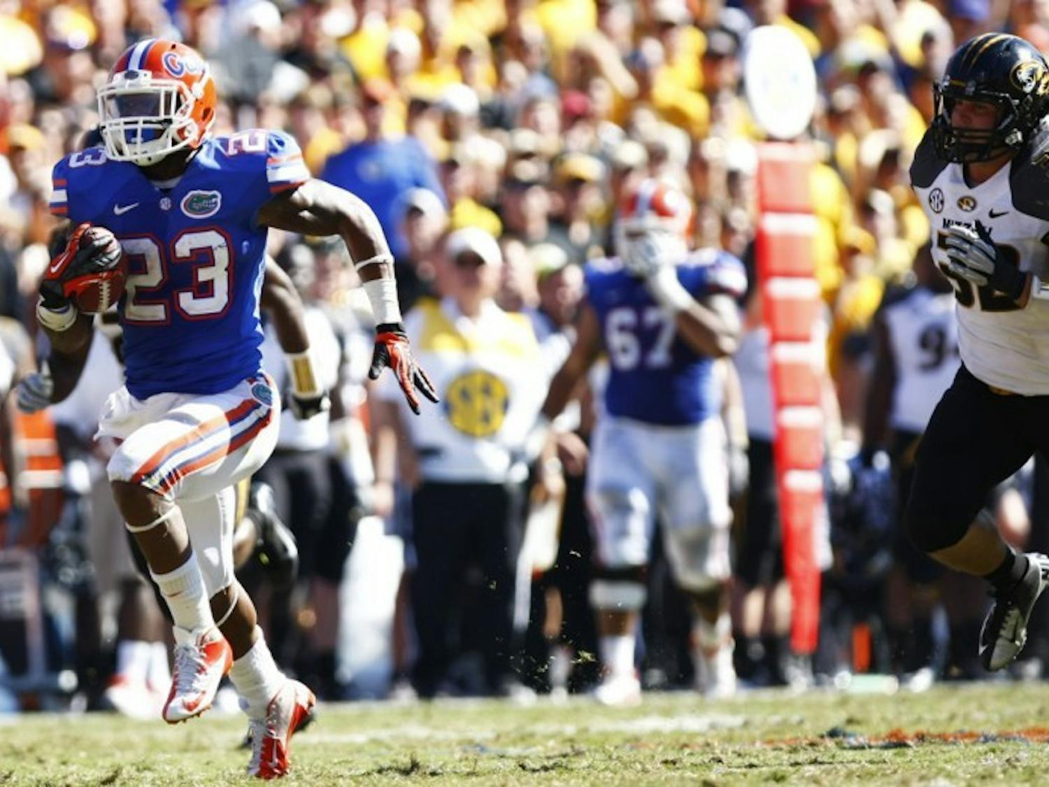 Running back Mike Gillislee (23) runs toward the end zone while being chased by Missouri linebacker Will Ebner (32) during Florida’s 14-7 win on Saturday at Ben Hill Griffin Stadium.
