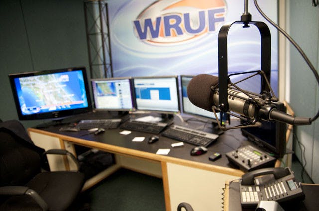 A microphone sits among computers and software in the studio of UF's 24-hour weather channel, WRUF-TV, located in the College of Journalism and Communications.