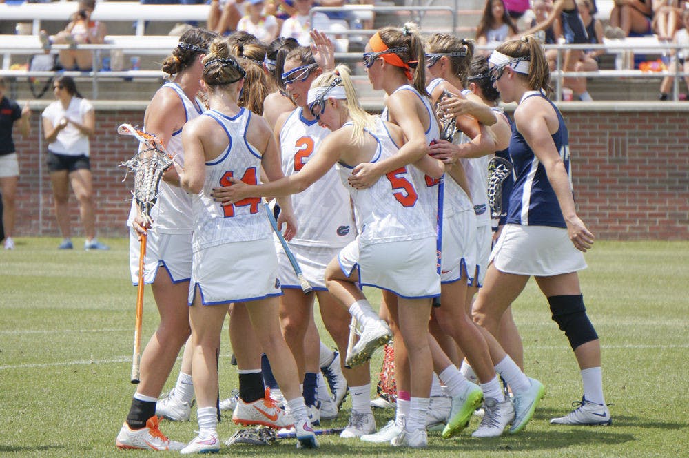 Florida lacrosse players celebrate after a goal during UF's 18-4 win against Georgetown on April 4 at Donald R. Dizney Stadium.