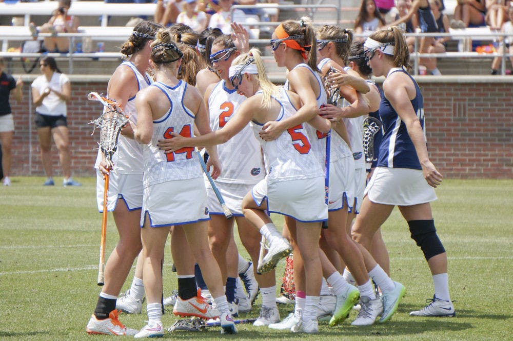 <p>Florida lacrosse players celebrate after a goal during UF's 18-4 win against Georgetown on April 4 at Donald R. Dizney Stadium.</p>