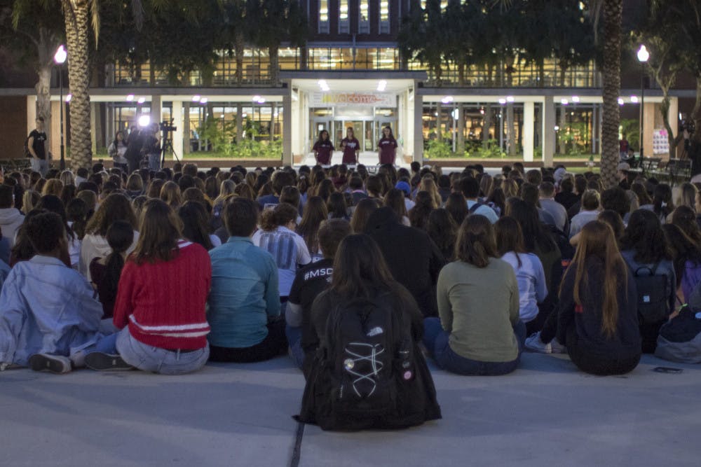 More than 200 people listen to six speakers Thursday on Plaza of the Americas during the vigil for the one-year anniversary of the Marjory Stoneman Douglas shooting.