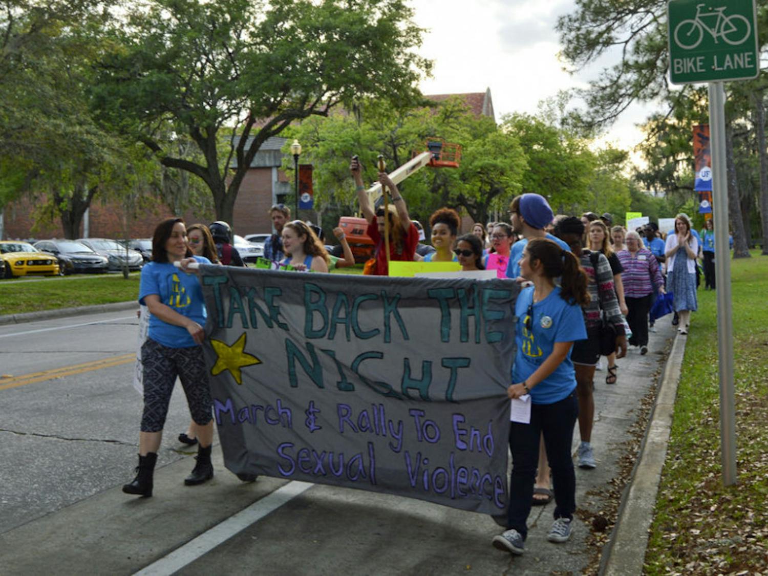 About 300 supporters march through UF campus Wednesday evening as part of the annual Take Back the Night event to raise awareness about sexual assault.