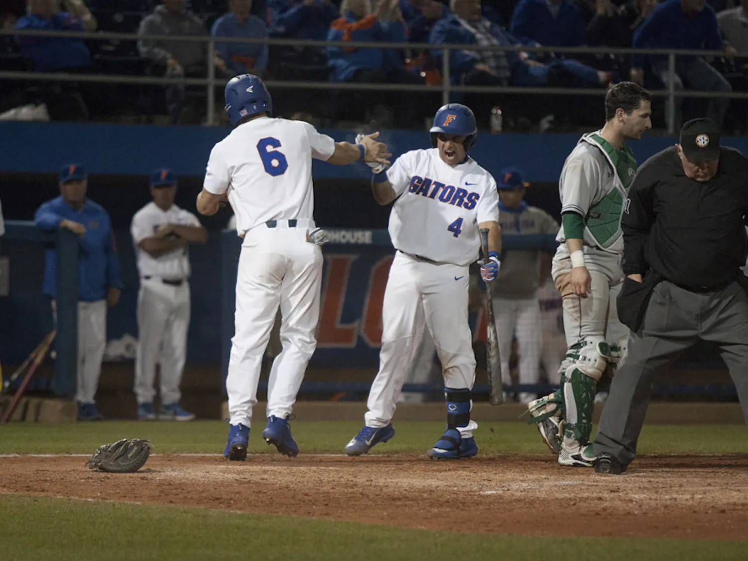 Mike Rivera, right, congratulates Jonathan India after he scored the eventual game-winning run during Florida's 5-4 win over William and Mary on Feb. 17, 2017, at McKethan Stadium.