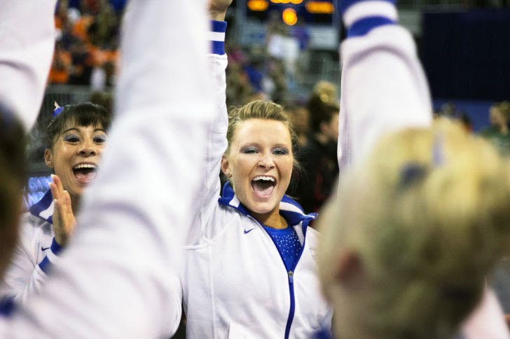Bridget Sloan celebrates during the NCAA Regionals on April 6 in the O’Connell Center. Florida won the meet with a score of 198.4. Sloan posted a 9.925 on uneven bars at the NCAA Championships Friday.&nbsp;