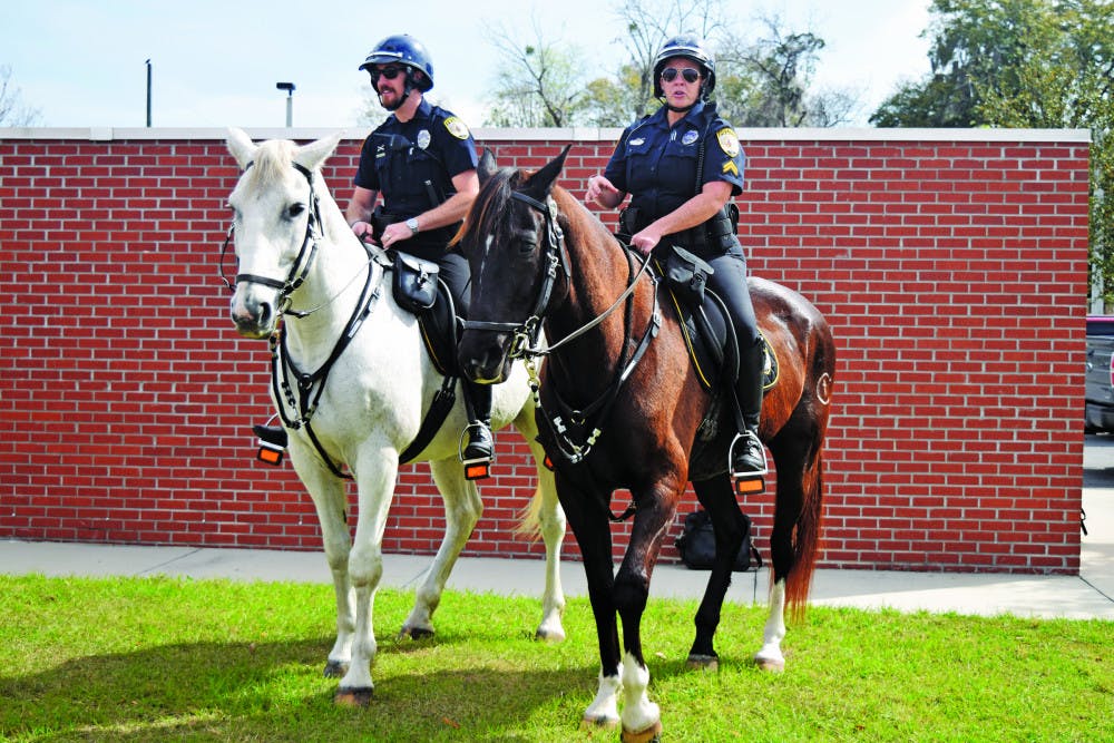 From left: Officer Ryan Foster rides Merlin and Cpl. Tracy Fundenburg rides Zeus. The two horses have been working for Gainesville Police’s mounted unit for about 10 years. On Tuesday, the horses retired. 