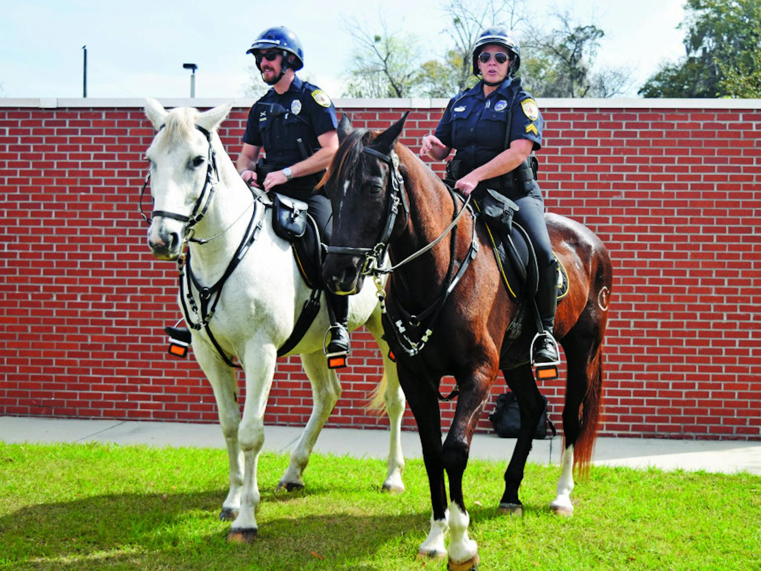 From left: Officer Ryan Foster rides Merlin and Cpl. Tracy Fundenburg rides Zeus. The two horses have been working for Gainesville Police’s mounted unit for about 10 years. On Tuesday, the horses retired. 