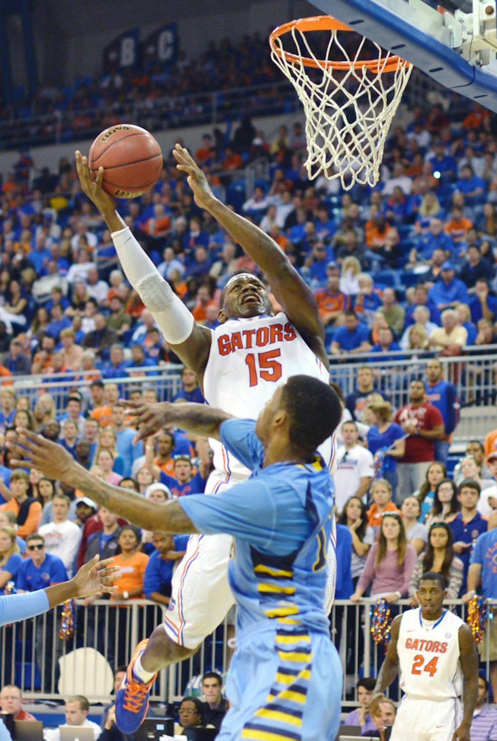 <p>Senior forward Will Yeguete attempts a layup over Marquette guard Vander Blue during Florida’s 82-49 victory against the Golden Eagles on Nov. 29 at the O’Connell Center. Yeguete averaged 5.5 points per game last season.</p>