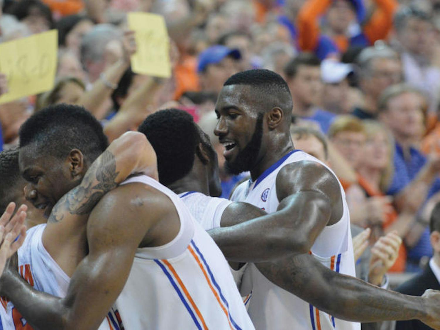 Gators basketball seniors Scottie Wilbekin, Will Yeguete, Casey Prather and Patric Young embrace after leaving the floor of the Stephen C. O’Connell Center for the last time during Florida’s 84-65 win against Kentucky on March 8.