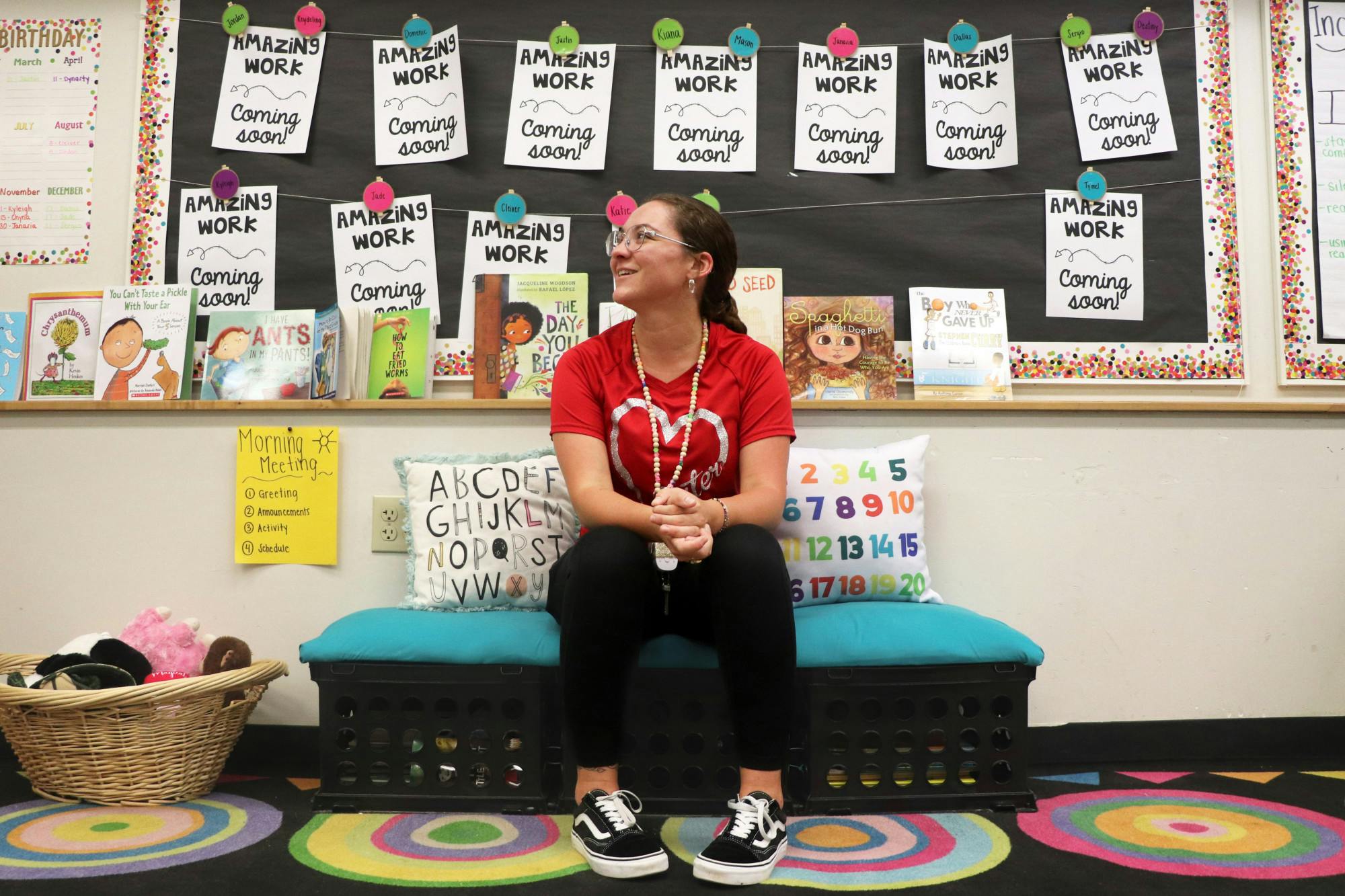 Third grade teacher Alayna Schwenker sits on a hand-made bench in the library corner of her classroom at Stephen Foster Elementary School Sept. 8, 2023.