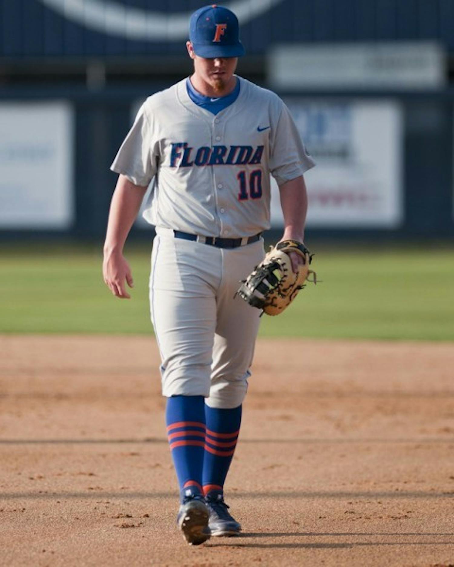 Florida first baseman and relief pitcher Austin Maddox walks off the field during UF’s 10-5 loss to North Florida on Tuesday. Maddox and the Gators combined to commit three errors.