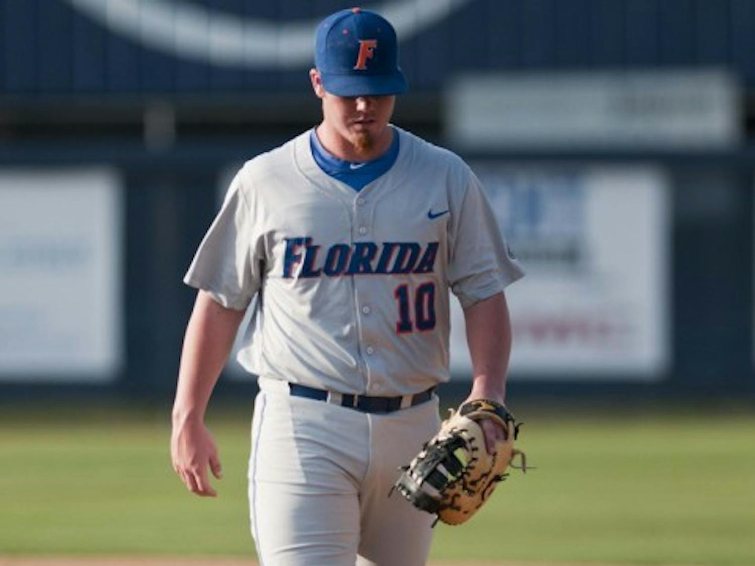 Florida first baseman and relief pitcher Austin Maddox walks off the field during UF’s 10-5 loss to North Florida on Tuesday. Maddox and the Gators combined to commit three errors.