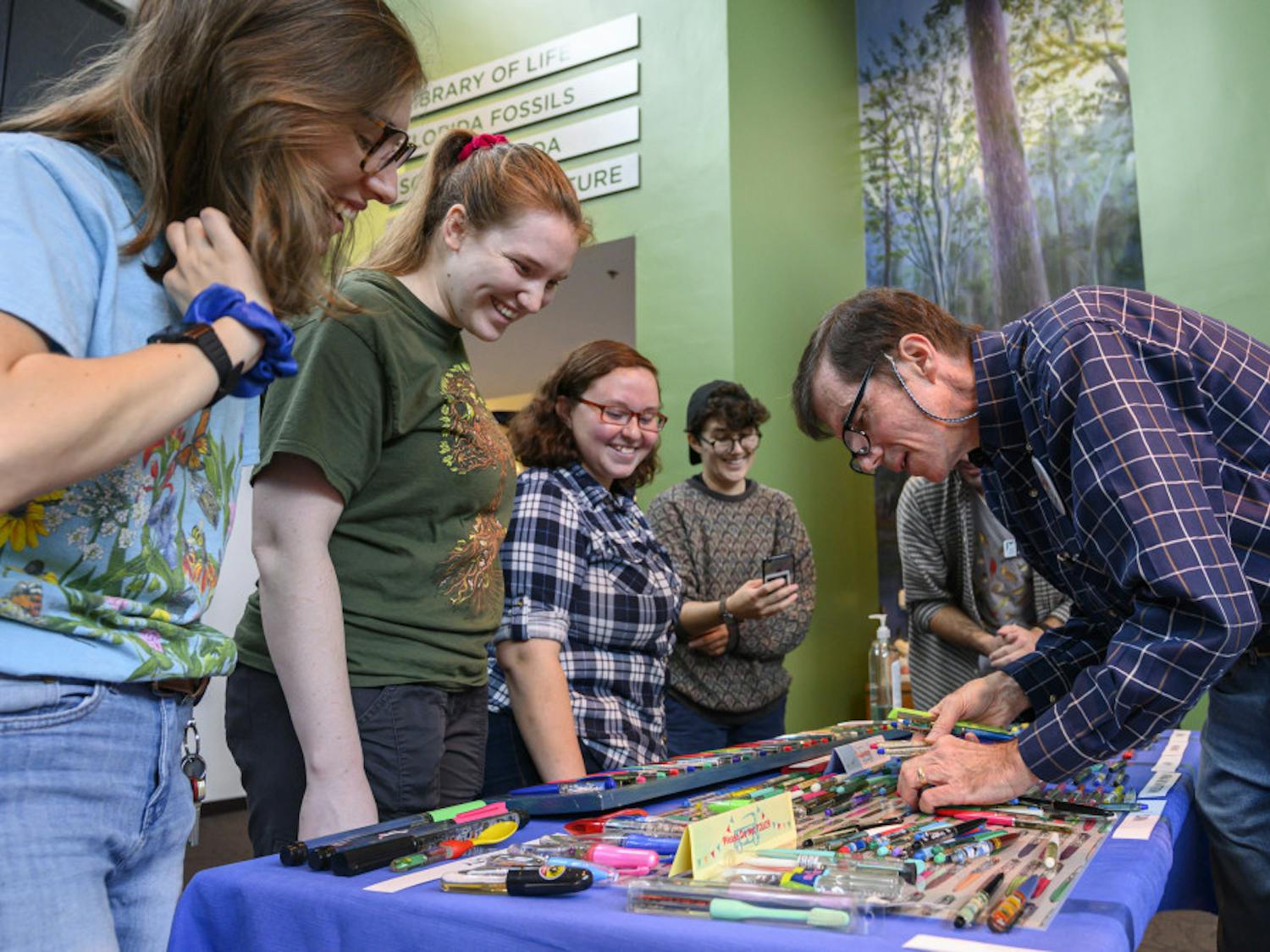 Jim Grantham, right, tells stories about his floaty pen collection to evengoers during the 41st Collectors Day at the Florida Museum of Natural History. Collectors Day is the Museum’s longest running event and attracts regional collectors of a variety of objects such as potato mashers, model ships, pop-up books and trains, each year.