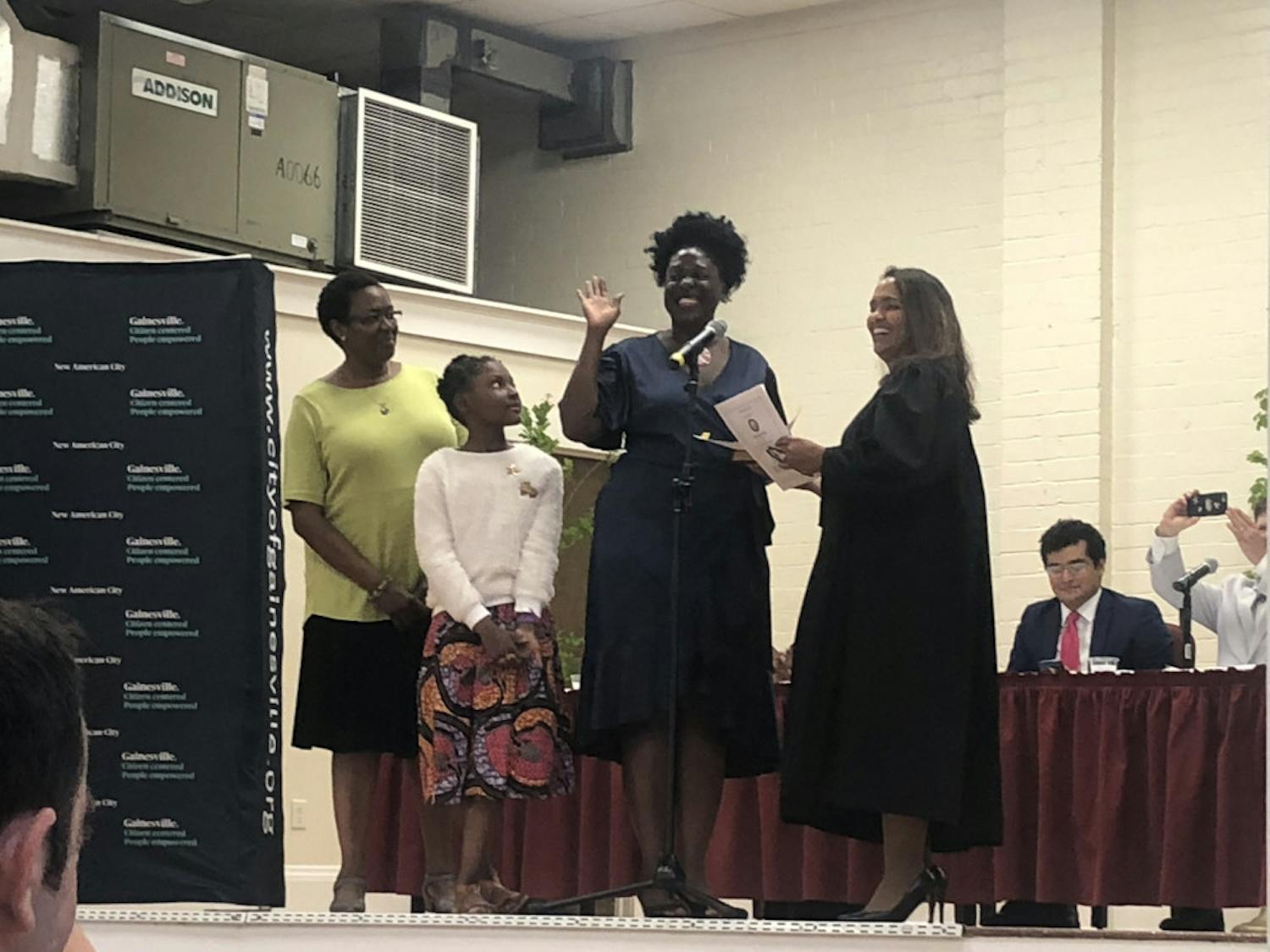 Gail Johnson (center right) is sworn into office alongside her daughter Zora (center left).