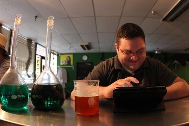 Product Development Engineer Derek Tabor, 30, enjoys a beer at The Laboratory, 818 W. University Ave. The bar reached out to patrons for donations after a rough summer drained its savings.
