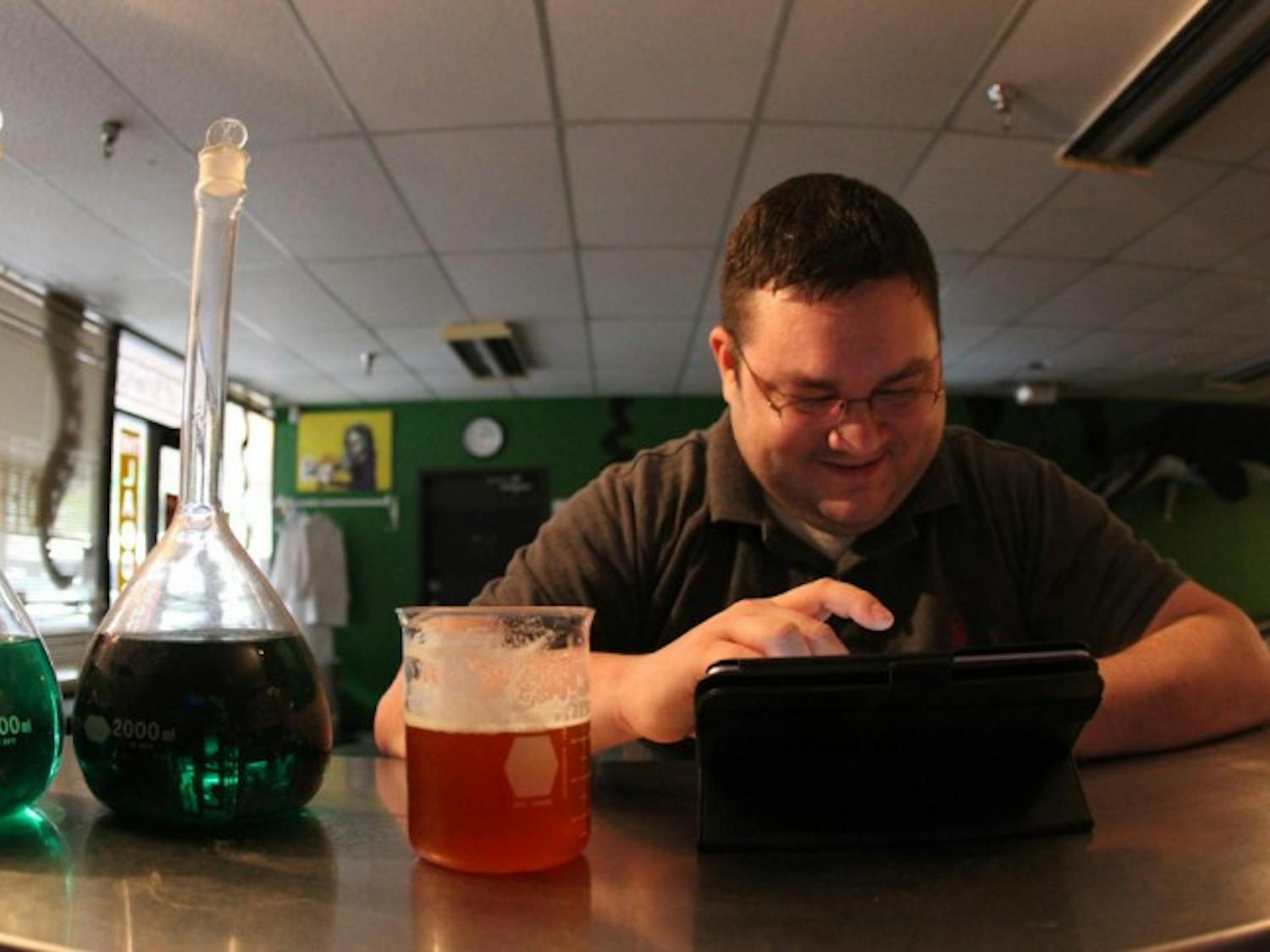Product Development Engineer Derek Tabor, 30, enjoys a beer at The Laboratory, 818 W. University Ave. The bar reached out to patrons for donations after a rough summer drained its savings.