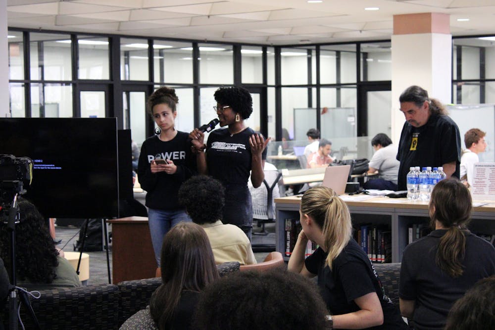 <p>Sophia De La Cruz (left) and Krystin Anderson (right) speak to attendees at the Samuel Proctor Oral History Program’s teach-in session about black history and intellectual freedom in Marston Science Library Thursday, February 23, 2023.</p>