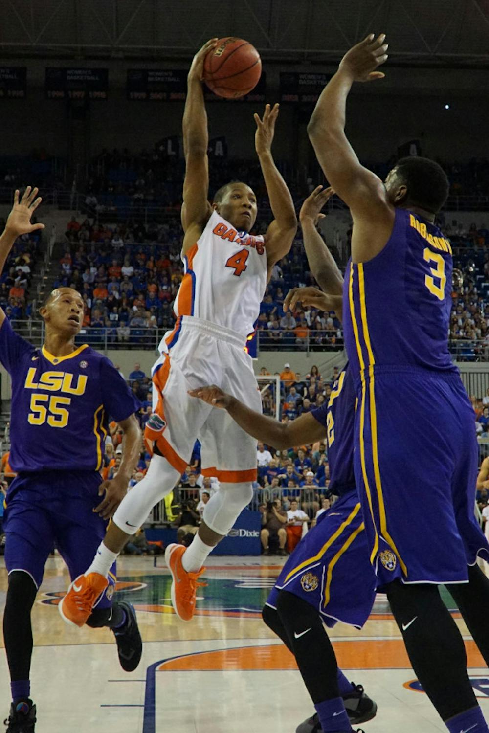 <p>UF guard KeVaughn Allen attempts to shoot over LSU’s Elbert Robinson III during Florida’s 68-62 win over LSU on Jan. 9, 2016, in the O’Connell Center.</p>