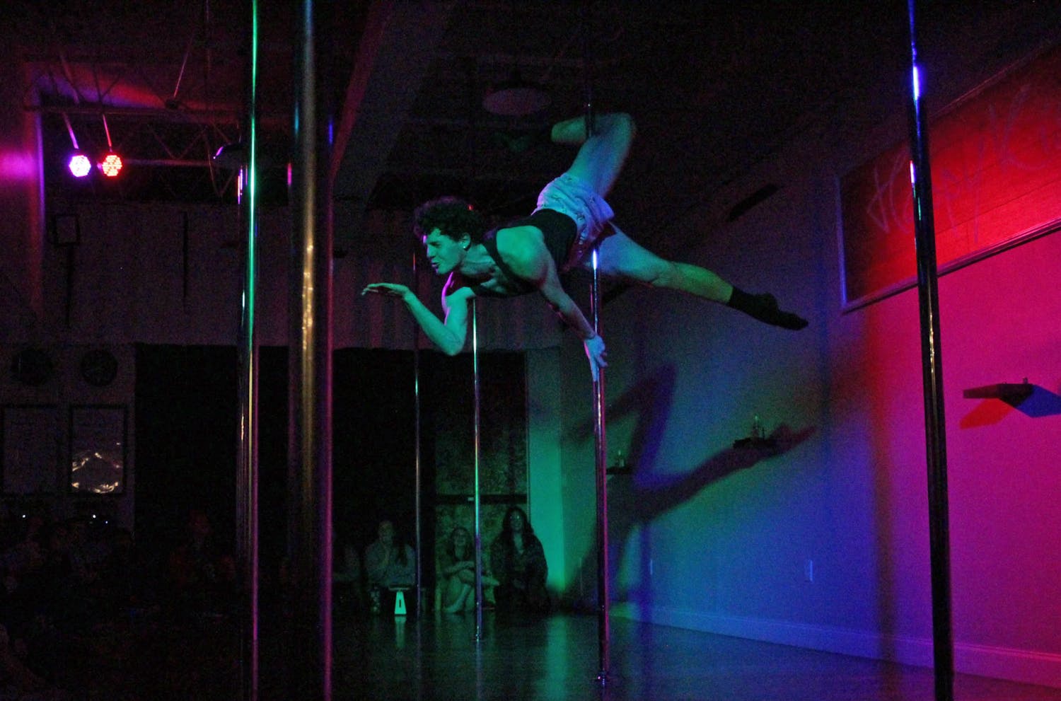 Nathan Wydra dances as the opening act to Happy Kiss Pole Fitness’ Jingle Jam and Showcase on Friday, Dec. 1, 2023.
