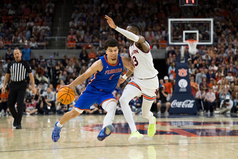 Florida Gators guard Walter Clayton Jr. (1) drives with the ball in a basketball game against Auburn University on Feb. 8, 2025, in Auburn, Ala.