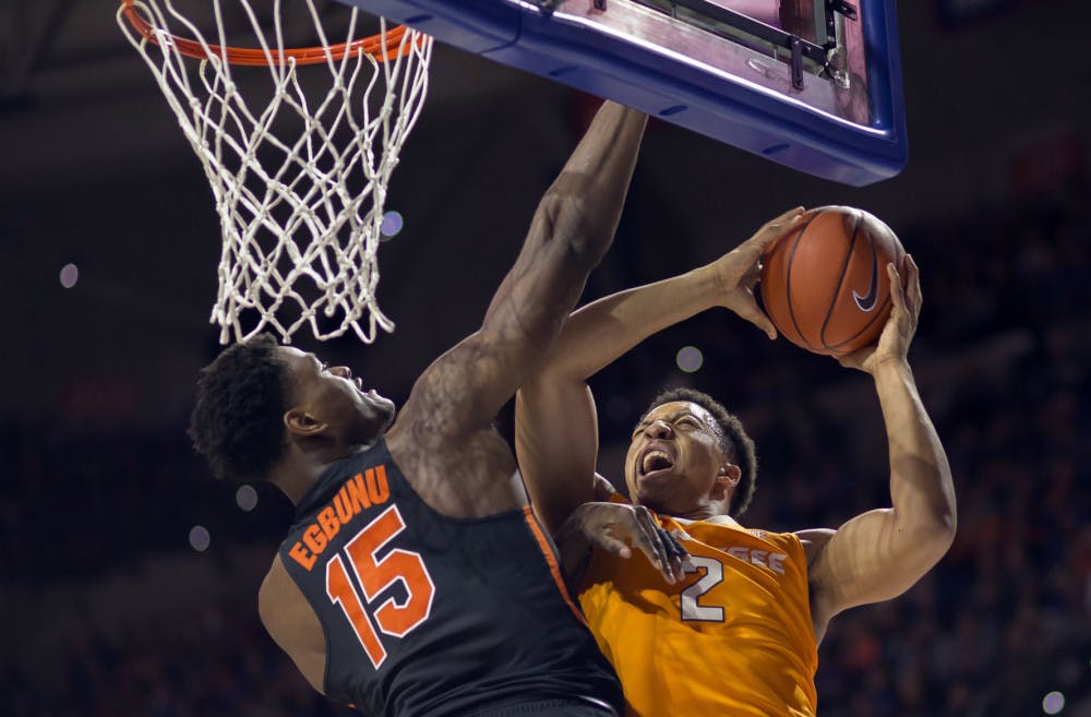 Florida center John Egbunu (15) fouls Tennessee forward Grant Williams (2) on this shot attempt during the first half of an NCAA college basketball game in Gainesville, Fla., Saturday, Jan. 7, 2017. (AP Photo/Ron Irby)