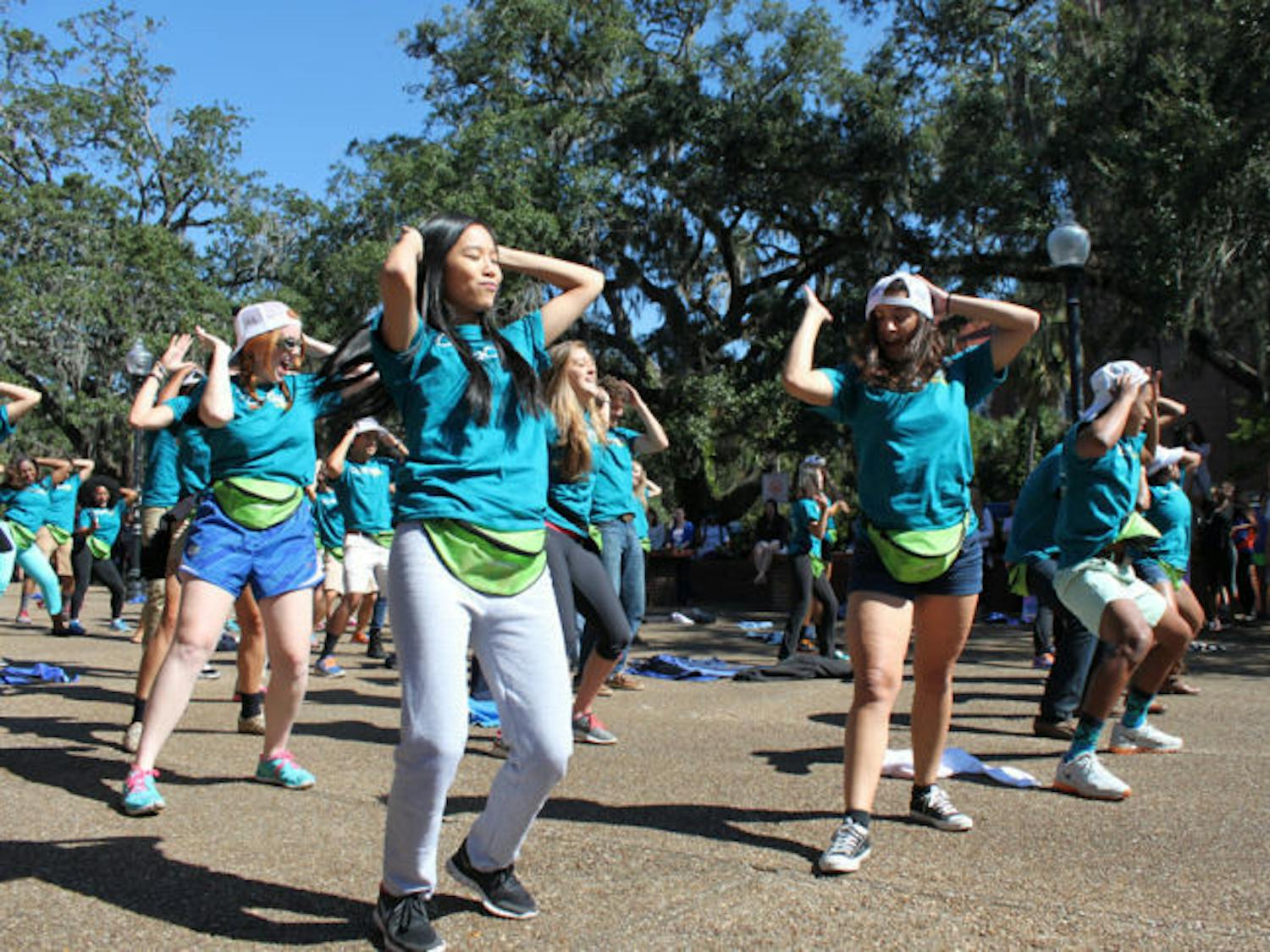 The Florida Cicerones perform a flash mob dance on Turlington Plaza on Monday afternoon as promotion for its Fall forum. The forum will take place at 6 p.m. today in Emerson Alumni Hall.