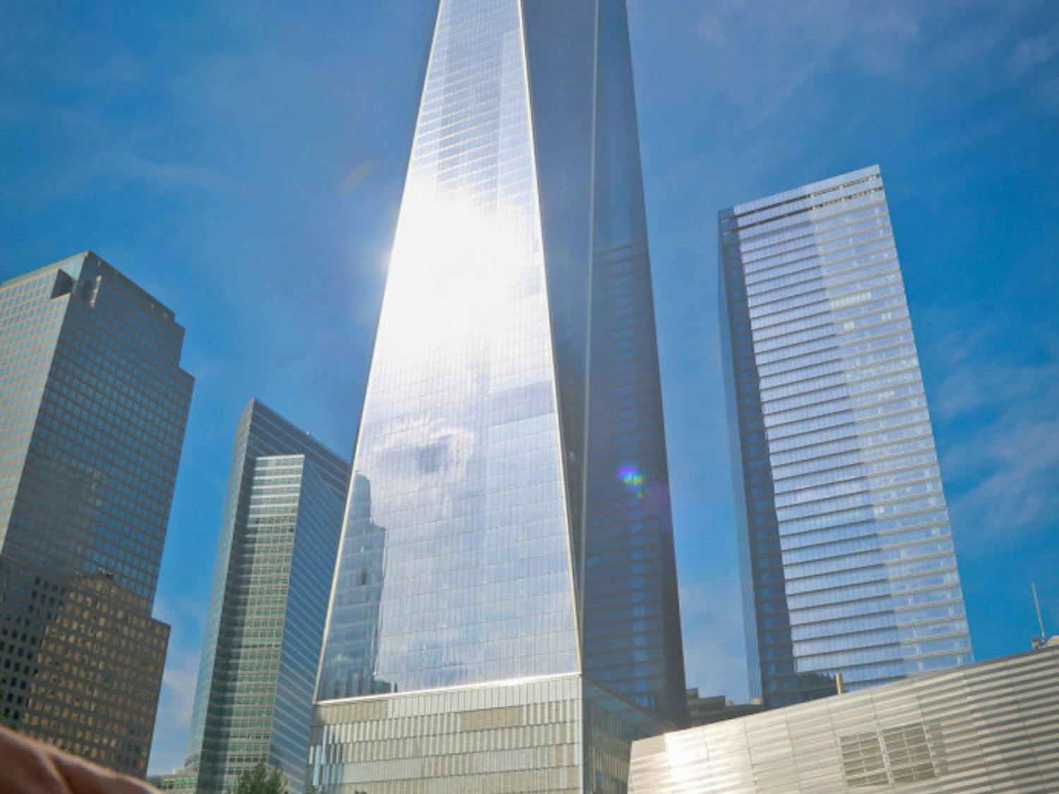 A visitor reaches to touch a name engraved at the Sept. 11 memorial site to remember the victims of the 2001 attacks on the World Trade Center, Thursday Sept. 8, 2016, in New York. Sunday marks the 15th anniversary of the terror attacks.