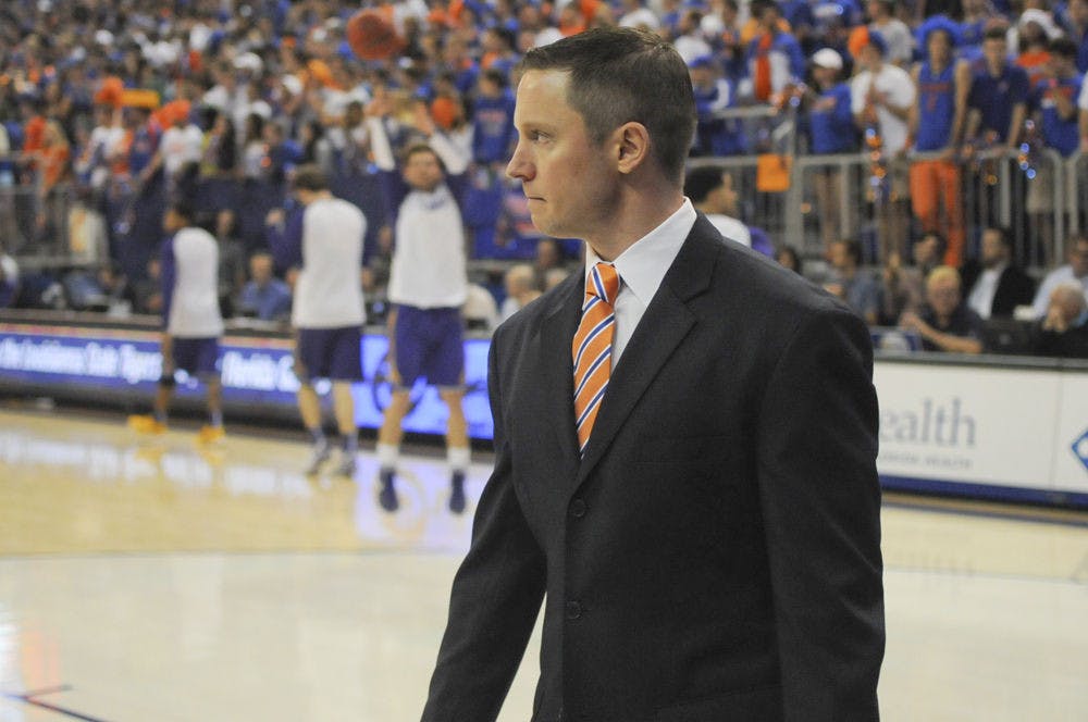 <p>UF coach Mike White walks onto the court prior to Florida’s 68-62 win over LSU on Jan. 9, 2016, in the O’Connell Center.</p>