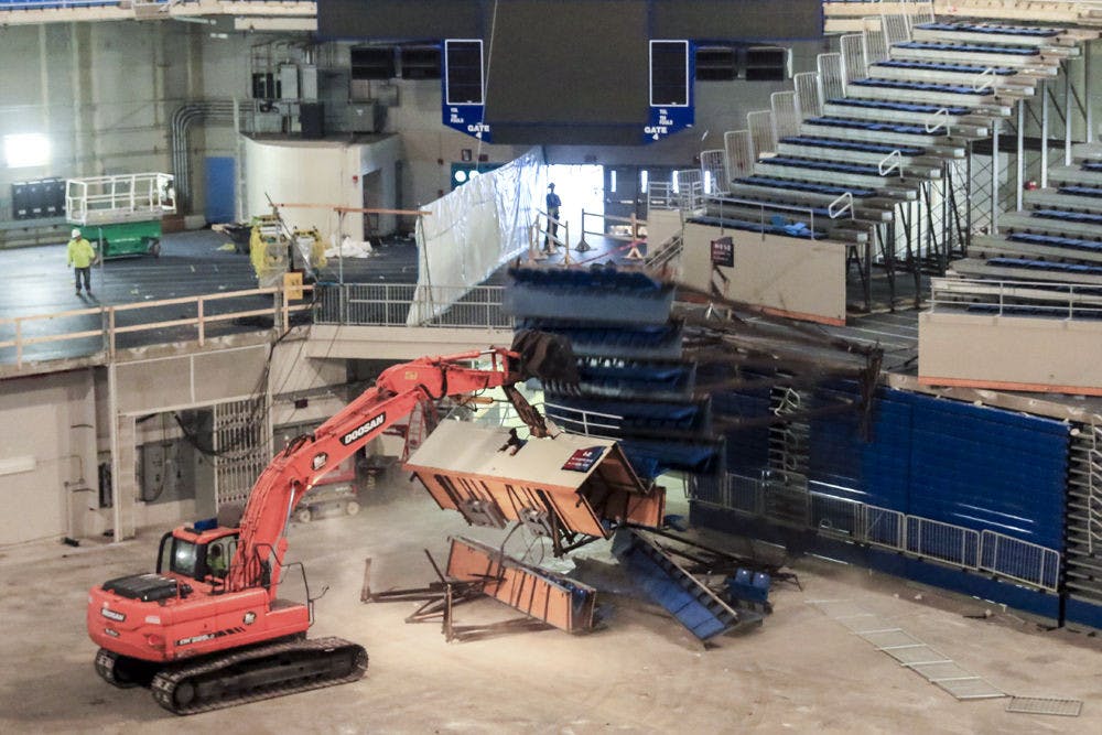 An excavator rips out a set of bleachers in the Stephen C. O’Connell Center as part of a $64.5 million renovation that will replace the seating with 10,500 chairbacks, 668 premium seats and a premium club lounge.