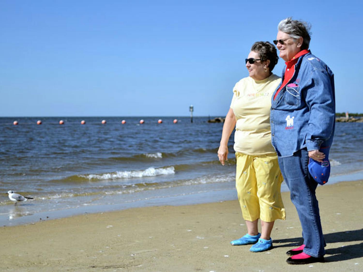 Petersen, left, and Grimes, right, stand on Fort Island Gulf Beach — their favorite getaway.