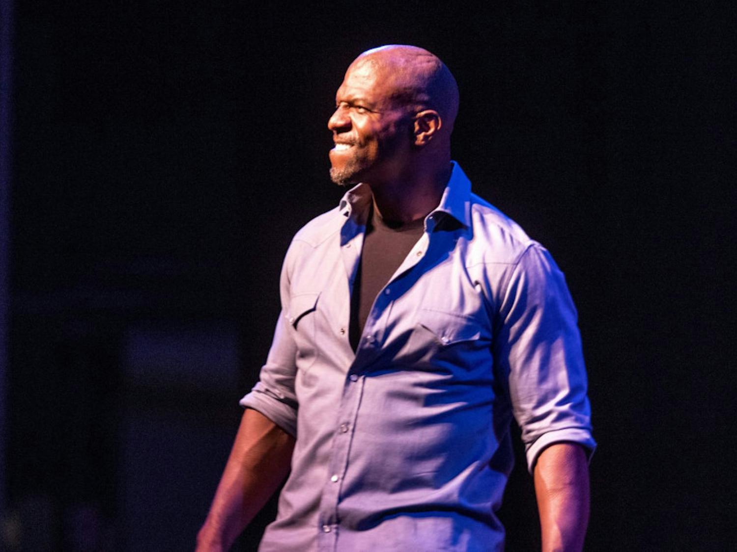 Terry Crews smiles for the crowd as he makes an enthusiastic entrance inside the Phillips Center for the Performing Arts on Tuesday night at the Accent Speakers Bureau-hosted event. Crews shared stories of rejection and perseverance along his journey of success.