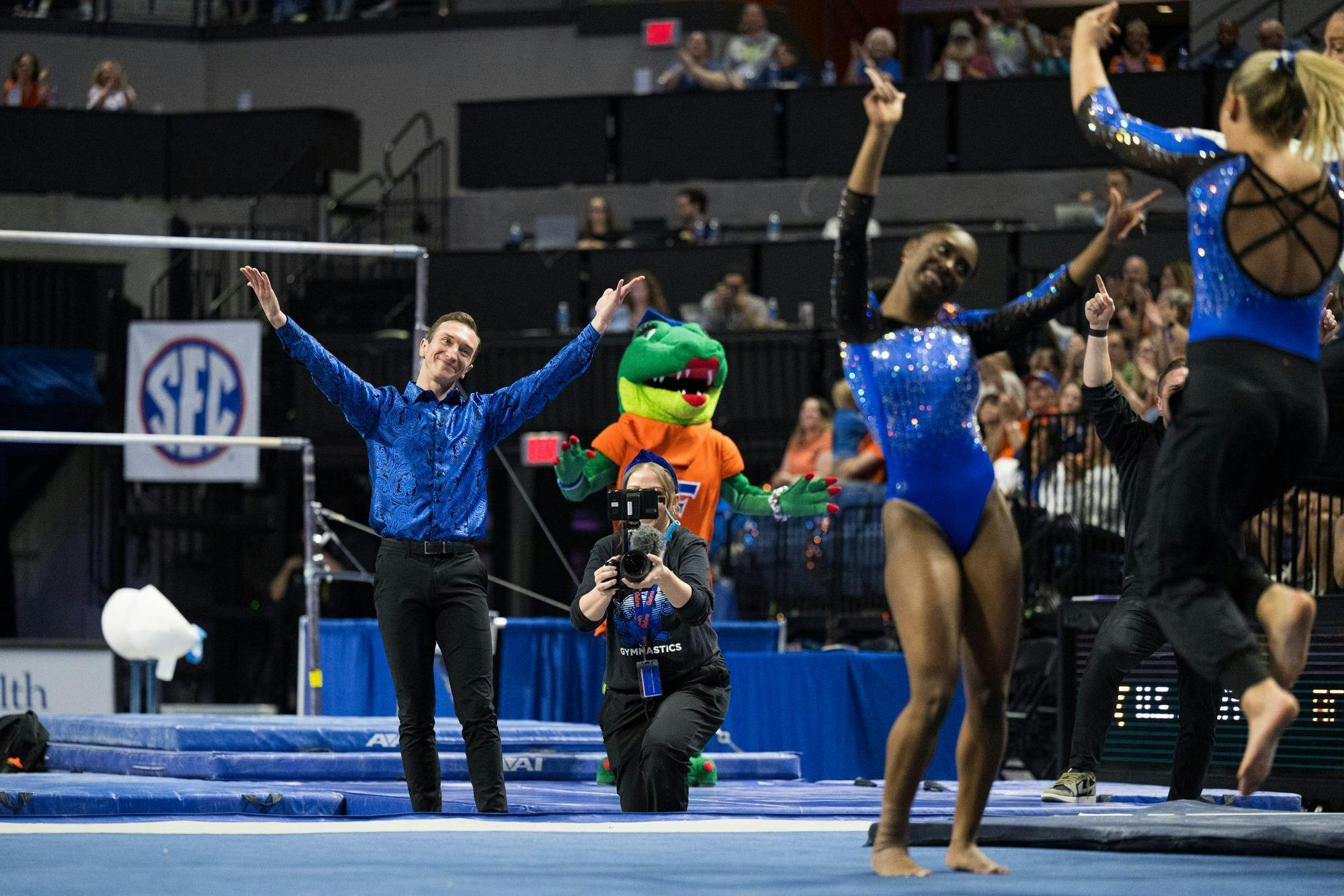 Florida Gators gymnastics Assistant Coach Jeremy Miranda mimics Taylor Clark during the end of her floor routine in a gymnastics meet against the Kentucky Wildcats in Gainesville, Fla., on Friday, March 14, 2025.