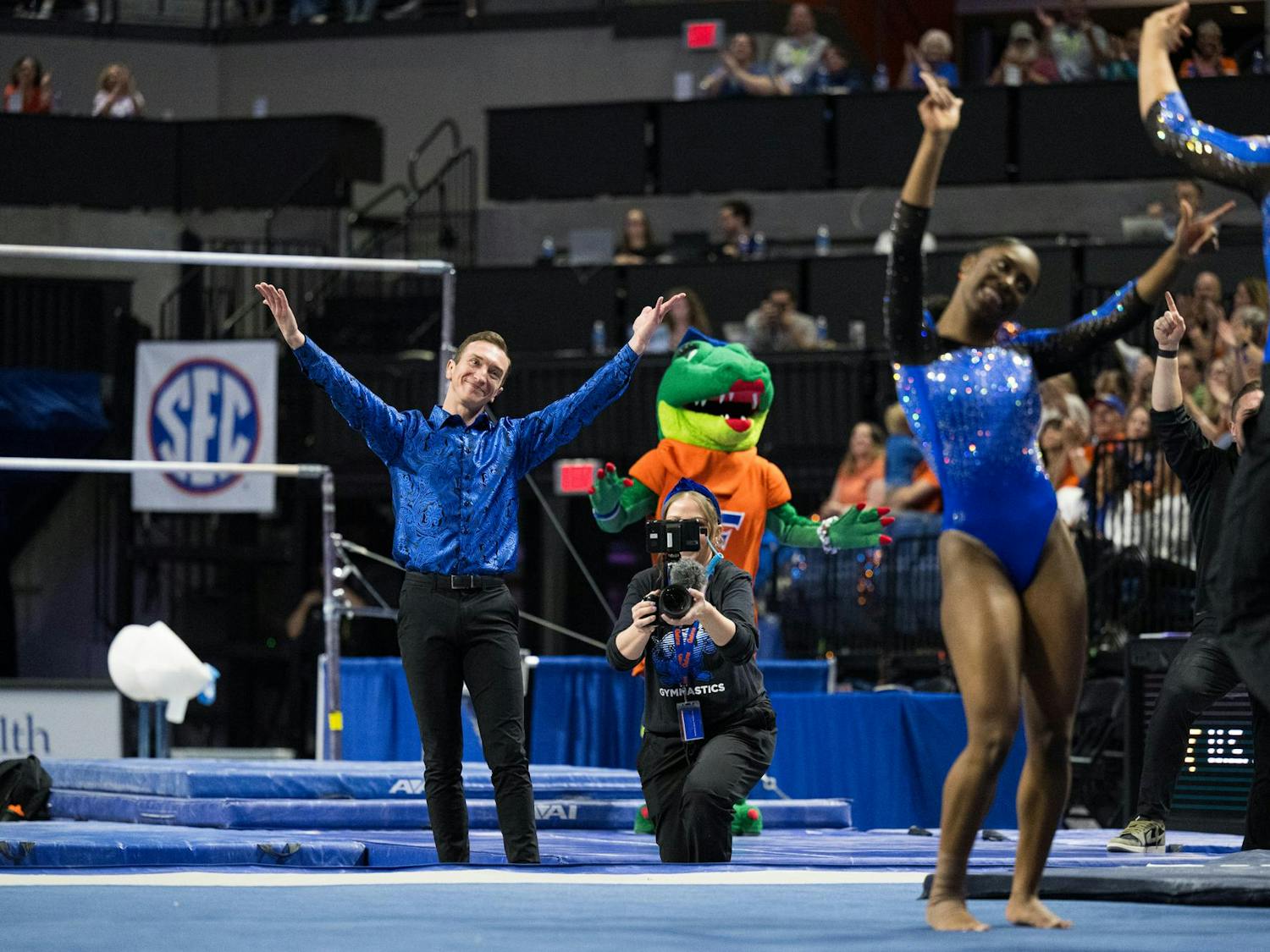 Florida Gators gymnastics Assistant Coach Jeremy Miranda mimics Taylor Clark during the end of her floor routine in a gymnastics meet against the Kentucky Wildcats in Gainesville, Fla., on Friday, March 14, 2025.