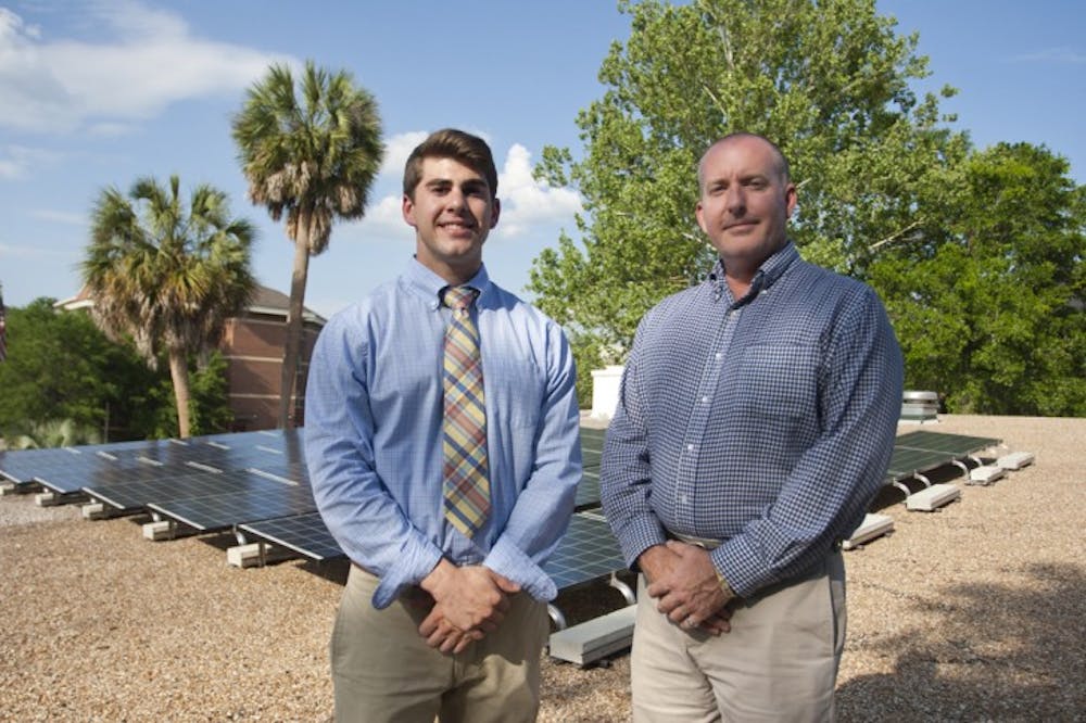 <p>Stuart Block and Patrick C. Wilber, a business development manager for Power Production Management Inc., pose on the roof of the Beta Theta Pi house Tuesday afternoon.</p>