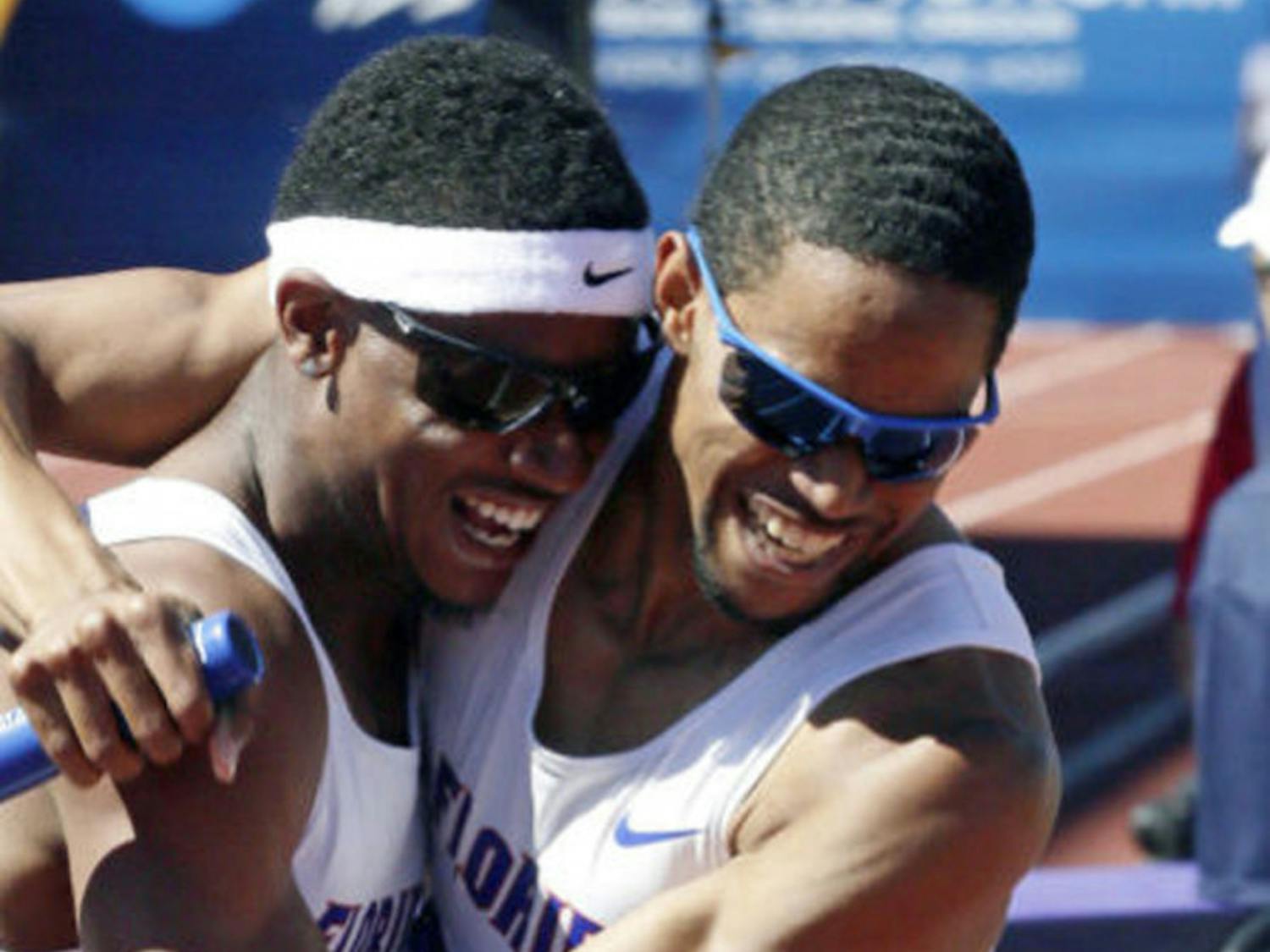 Hugh Graham Jr. (left) hugs Arman Hall after winning the 4x400m relay during the NCAA Outdoor Championships in Eugene, Ore., on Jun. 8, 2013.