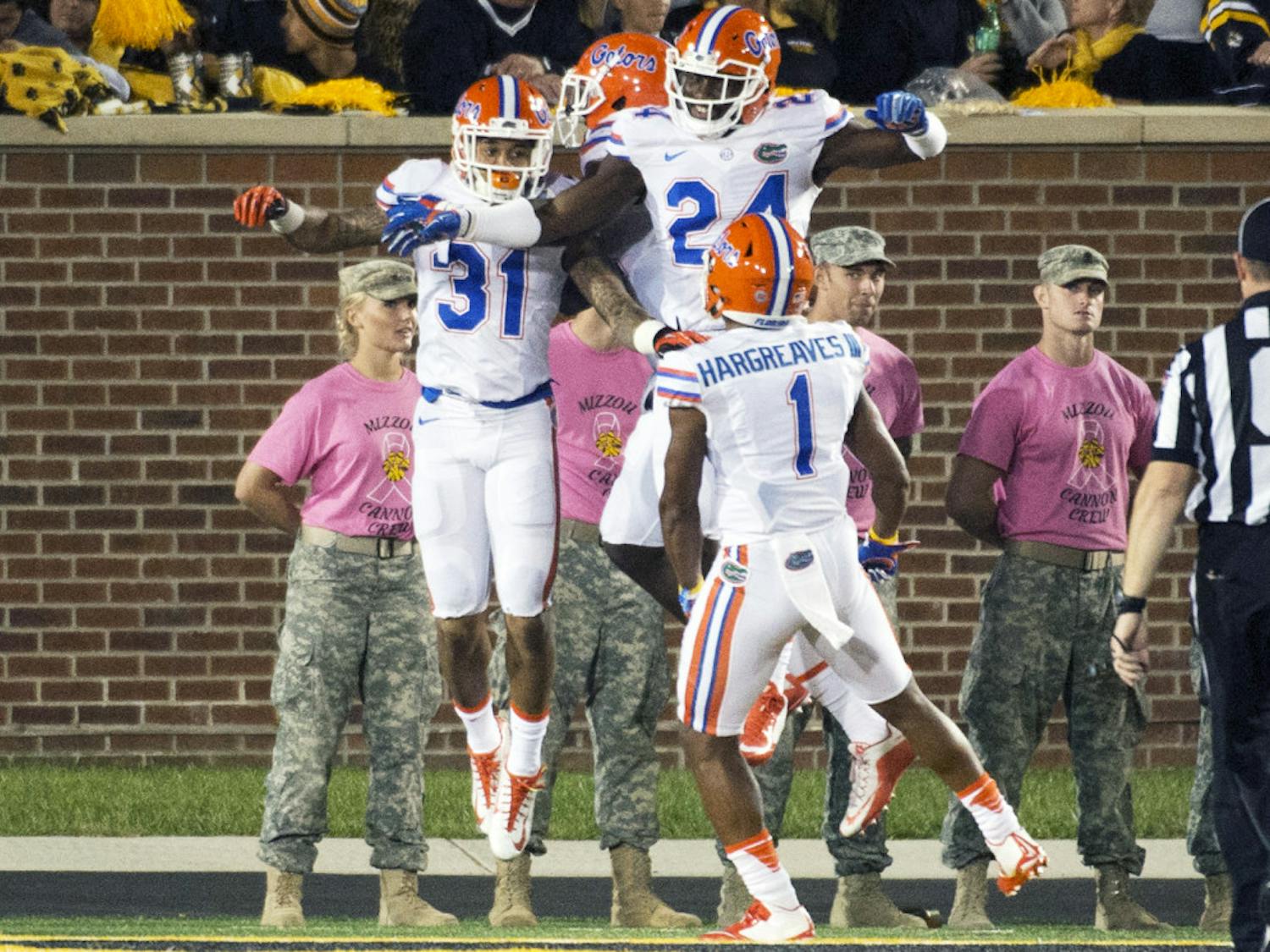 Florida defensive back Jalen Tabor, left, celebrates with teammates after he returned an interception for a touchdown during the second half of an NCAA college football game against Missouri, on Oct. 10 2015, in Columbia, Missouri.