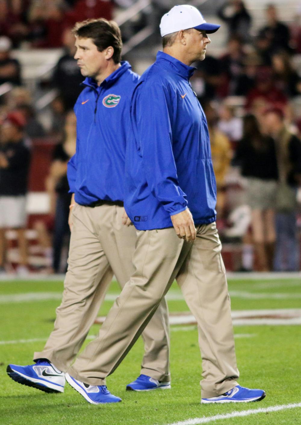 <p>Brent Pease parts ways with Florida coach Will Muschamp prior to Florida’s 19-14 loss to South Carolina on Nov. 9 at Williams-Brice Stadium in Columbia, S.C. Pease was fired Sunday afternoon.</p>