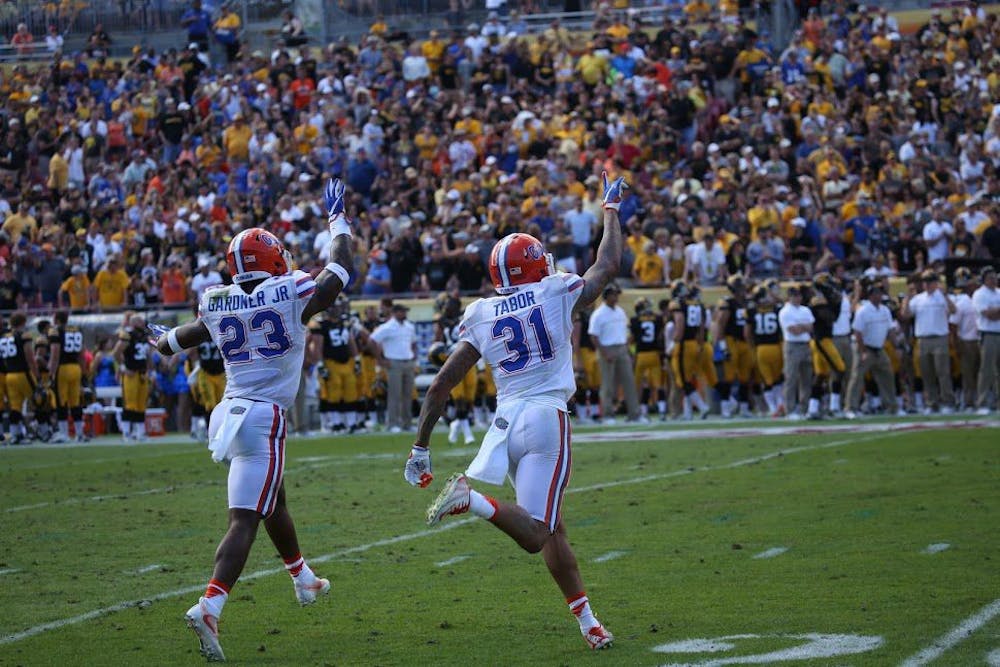 <p>Florida defensive backs Chauncey Gardner and Jalen Tabor celebrate during UF's 30-3 Outback Bowl victory over Iowa on Monday, Jan. 2, at Raymond James Stadium.&nbsp;</p>