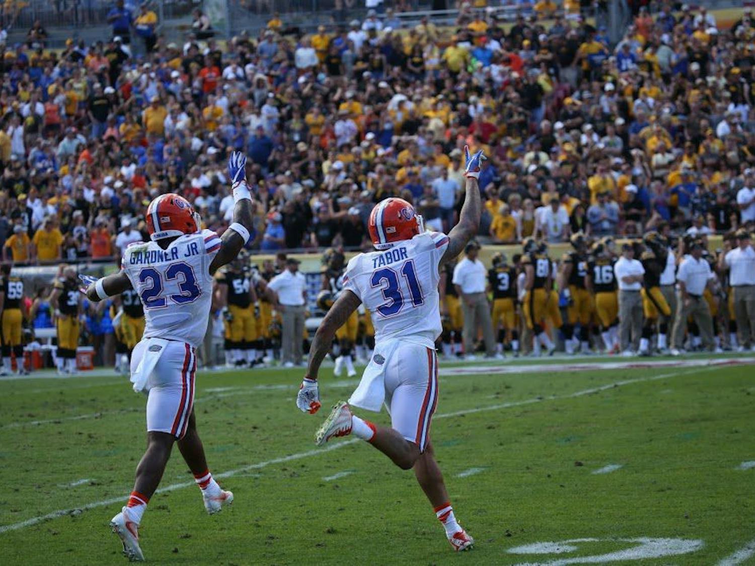 Florida defensive backs Chauncey Gardner and Jalen Tabor celebrate during UF's 30-3 Outback Bowl victory over Iowa on Monday, Jan. 2, at Raymond James Stadium. 