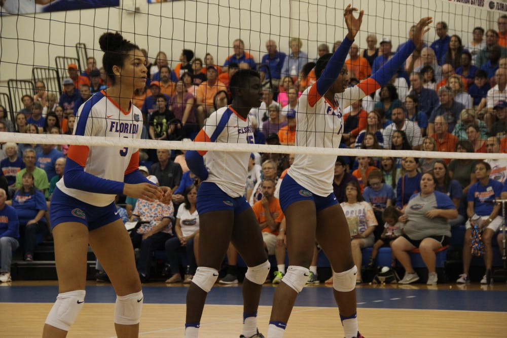 <p>From left: Alex Holston, Shainah Joseph and Rhamat Alhassan wait for play to resume during Florida's 3-0 win over Mississippi State on Oct. 21, 2016, at the Lemerand Center.</p>
