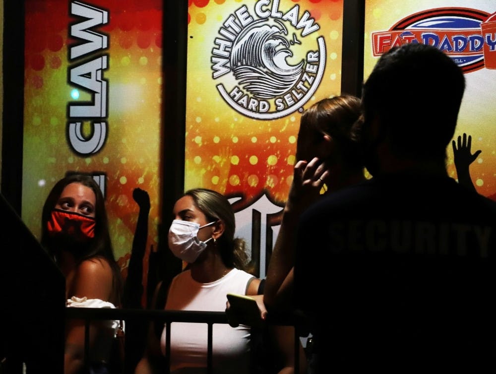 A group of people wait in line at Midtown to enter “Fat Daddy’s,” a bar in Gainesville on August 28, 2020. This was the bar’s first night reopening for the fall semester.