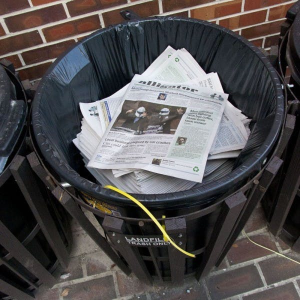 A stack of Alligator newspapers sit unread in a trash bin at Weimer Hall on Monday morning.
