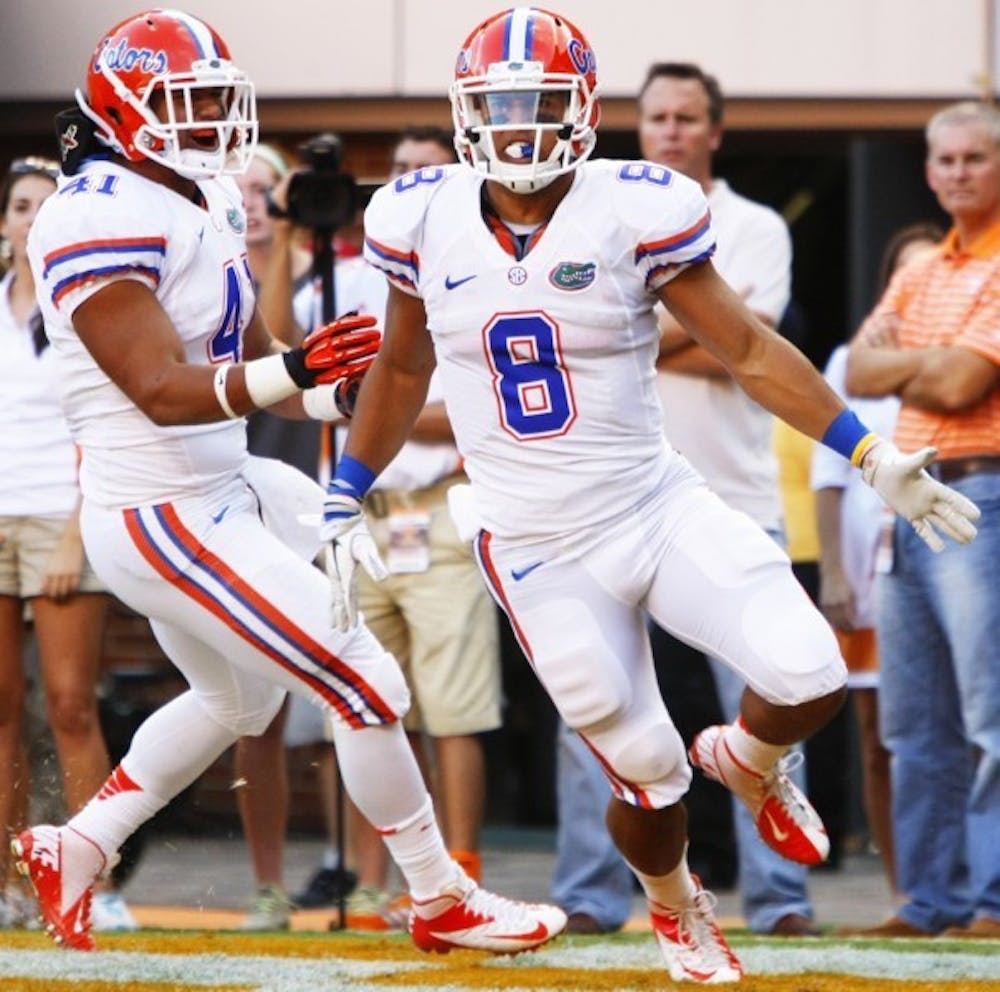<p>Running back Trey Burton (8) celebrates after scoring in his first trip to the red-zone at Neyland Stadium on Saturday.</p>