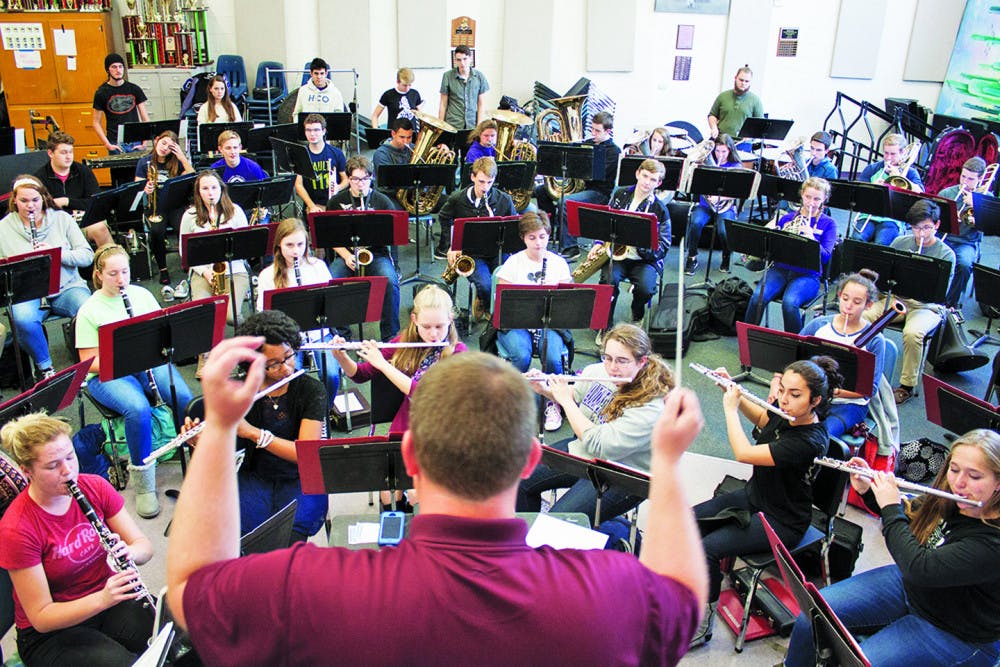 Bill Pirzer, director of bands at Gainesville High School, conducts the GHS band during practice on Tuesday. The band is trying to raise funds for a trip to the Cherry Blossom Festival Parade in Washington, D.C., in April. 