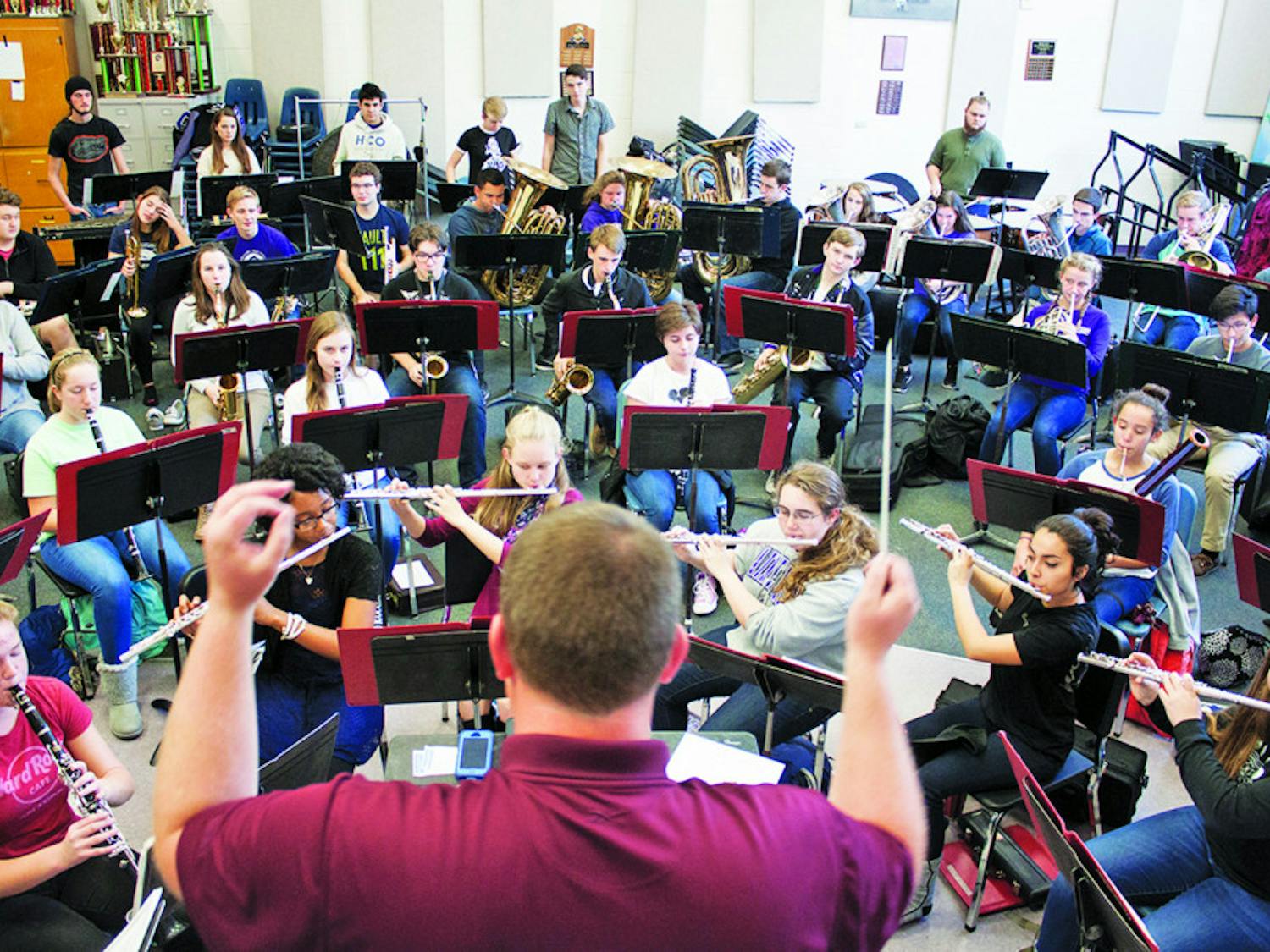 Bill Pirzer, director of bands at Gainesville High School, conducts the GHS band during practice on Tuesday. The band is trying to raise funds for a trip to the Cherry Blossom Festival Parade in Washington, D.C., in April.