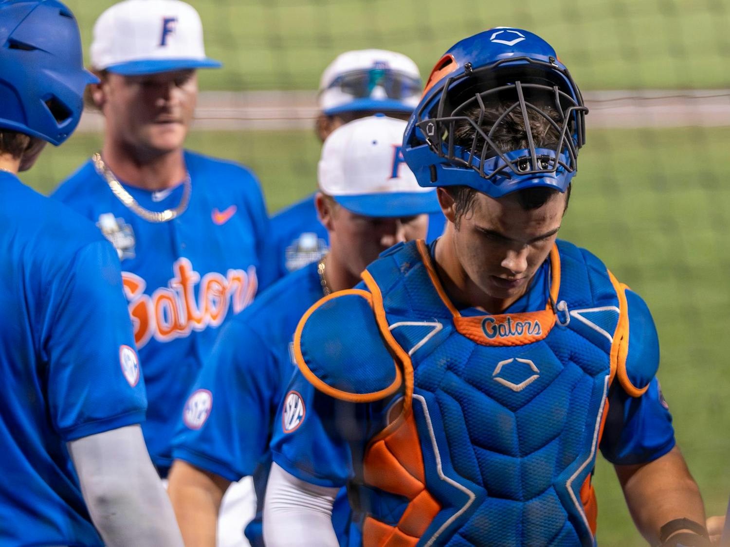 Florida catcher Luke Heyman walks off the field after losing their first College World Series game to Texas A&M on Saturday, June 15, 2024.