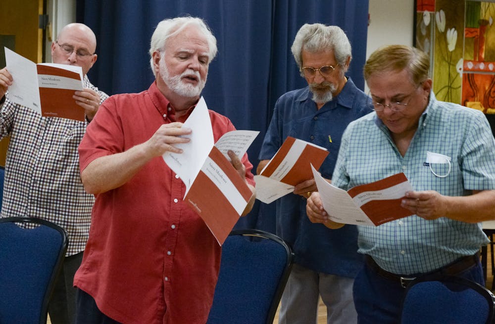Willard Kesling (second from left), a UF choral professor and music director and conductor for the ShabbaTones Jewish choir, leads the baritone section of the ShabbaTones in a choir practice on Wednesday, July 28, 2021. "I will not let art, not let culture die," Kesling said, before the group began their first in-person choir practice since the COVID-19 pandemic halted performances in early 2020. 